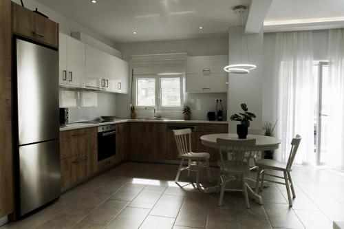 a kitchen with a table and chairs and a refrigerator at StelAnna-Apartments in Rethymno Town