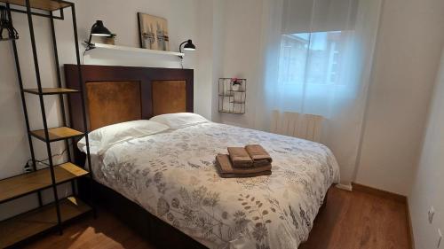 a bedroom with a bed with a purse on it at Apartamento Cantabria Verde in Los Corrales de Buelna