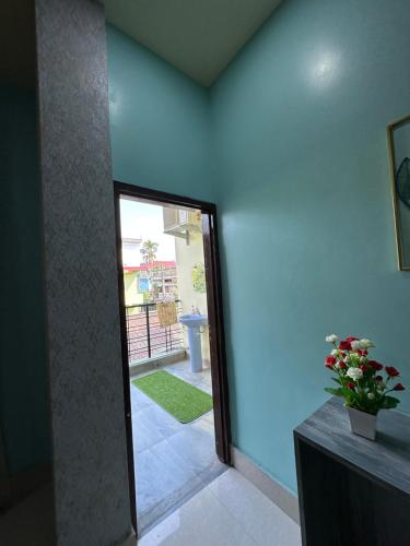 a room with a door leading to a patio at SK Luxury Homestay in Sivasagar