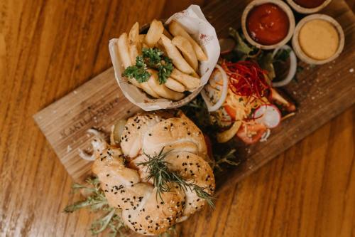 a plate of food with a sandwich and french fries at Munduk Heaven Luxury Villas in Munduk