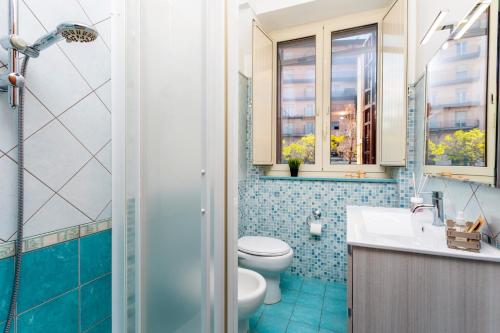 a bathroom with a toilet and a sink and a shower at Civico 1 Apt - Acireale in Acireale