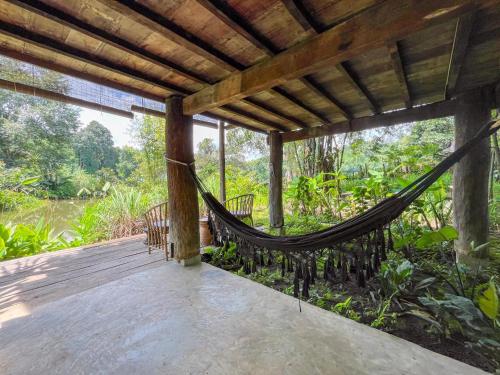 a hammock on the porch of a house at NernJamsai in Sop Poeng