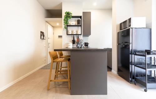 a kitchen with a counter and a refrigerator at CentroNovara Free Netflix-Wi-Fi in Novara
