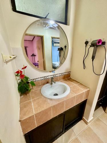 a bathroom with a sink and a mirror at A Famosa Resort sunset 1075 villa 4 bathroom 6 bedroom karaoke bbq snooker in Kampong Ulu Pegoh