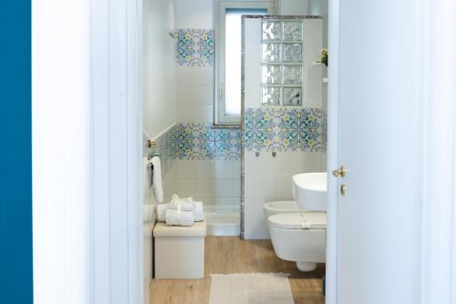 a bathroom with a toilet and a sink at Villa Da Vinci Luxury Panoramic Apartments - Taormina rooms collection in Taormina