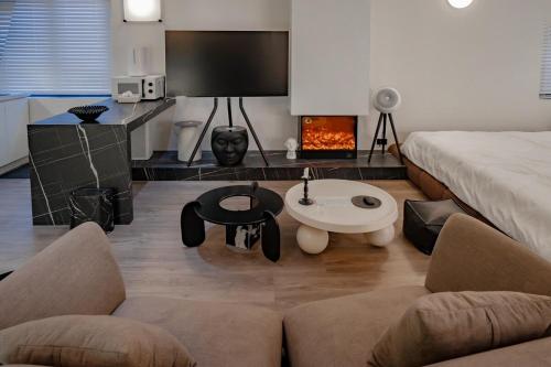 a living room with a couch and a fire place at Do Studioishome Homestay Dukkha 03 in Ha Long