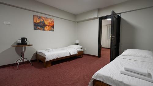 a hotel room with two beds and a mirror at Forrest in Głogów Małopolski
