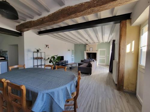 - une salle à manger et un salon avec une table dans l'établissement Maison à louer, à Beaumont-Pied-de-Boeuf