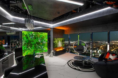 a living room with a view of a city at 30th+ Floor Apartments in Sky Tower in Wrocław