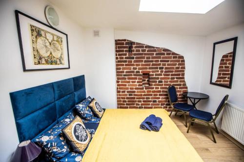 a room with a bed and a brick wall at Planetarium - Stare Miasto, Parking Free in Toruń