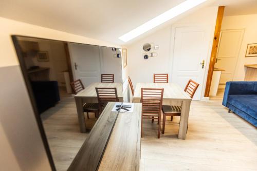 a dining room with a table and chairs and a blue couch at Planetarium - Stare Miasto, Parking Free in Toruń