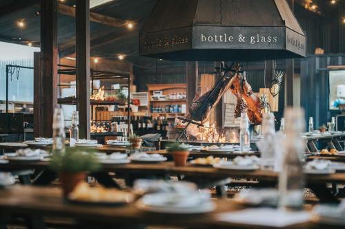 a restaurant with plates of food on tables at The Bottle & Glass Inn - Book All 3 Rooms in Henley on Thames