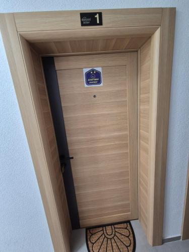 a large wooden door with a sign on it at Apartmani Banjski Biser in Jošanička Banja
