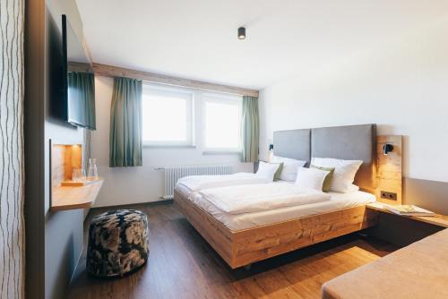a hotel room with a bed and a window at Gasthaus Zum Kreuz in Sankt Märgen