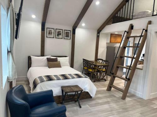 a bedroom with a bed and a ladder and a chair at Watershed- IN TOWN walk to everything in Lava Hot Springs
