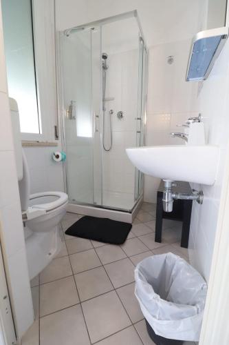 a bathroom with a sink and a shower and a toilet at Fasthotel in Cervia