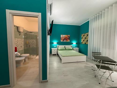 a bedroom with a bed and a bathroom with a shower at La Casa di Armando in Agrigento