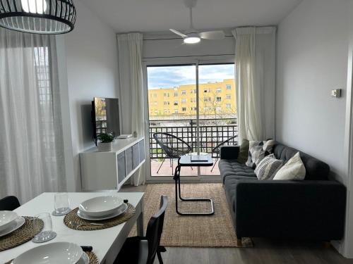 a living room with a couch and a table at Apartamento palafrugell parking y wifi gratis in Palafrugell