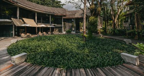 a building with a large field of plants in front of it at The Dewa Koh Chang in Ko Chang