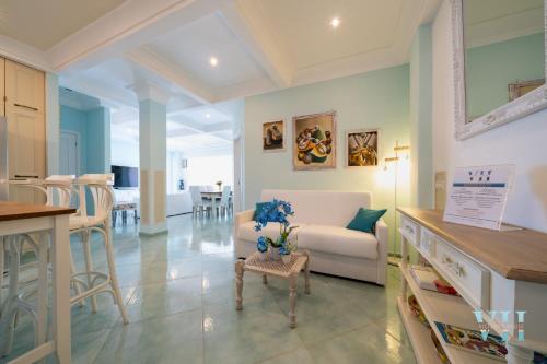 a kitchen and living room with a couch and a table at Victory's Luxury House with Jacuzzi on the Roof in Ischia