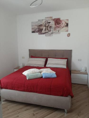 a bedroom with a red bed with two pillows on it at Casa Gemma in Gravedona