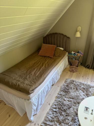 a bed in the corner of a room at Rosbacken in Stockholm