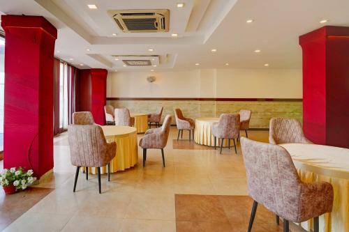 a conference room with tables and chairs and red walls at Super Townhouse Prince Chowk Near Railway Station in Dehradun