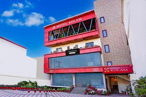 a red building with flowers in front of it at Super Townhouse Prince Chowk Near Railway Station in Dehradun