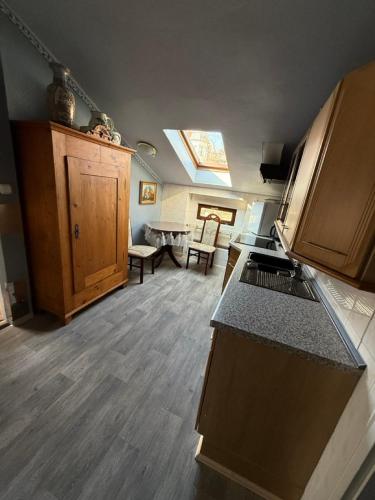 a kitchen with a skylight and a living room at Pension am Tiefen See in Potsdam