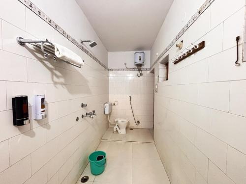 a small bathroom with a toilet and a phone at Jai Villa Homestay in Prayagraj