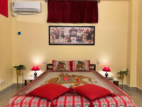 a bedroom with a large bed with red pillows at Earth Yoga Luxury Apartments in North Lakhimpur