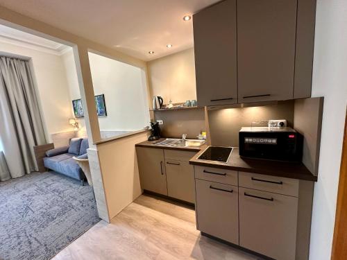 a small kitchen with a sink and a microwave at Hotel Central in Bamberg