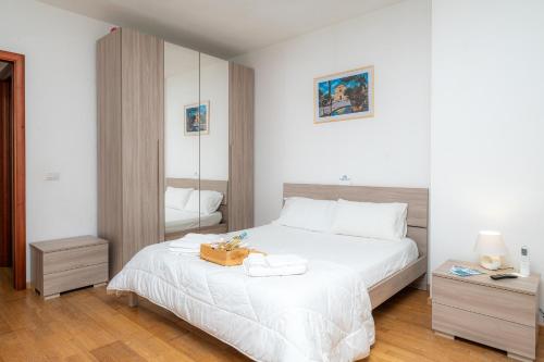 a bedroom with a white bed with a box on it at Affittacamere - Il Vicoletto in Porto Torres