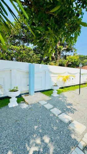 two toilets sitting on the ground next to a white wall at Yahana Beach Villa in Negombo