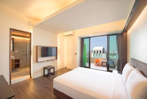 Postel nebo postele na pokoji v ubytování 嬉安平 Si Anping by Hotel Si