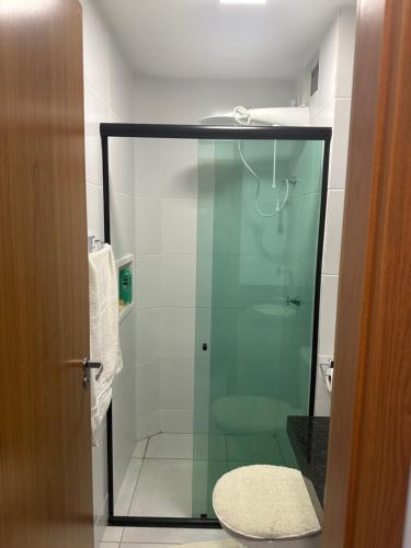 a glass shower in a bathroom with a toilet at Apartamento completo em Salinópolis in Salinópolis