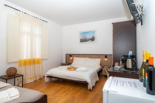 a room with two beds and a refrigerator in it at Affittacamere - Il Vicoletto in Porto Torres