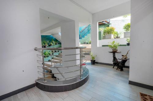a spiral staircase in a room with white walls at Ark Cabin Villa in Kandy