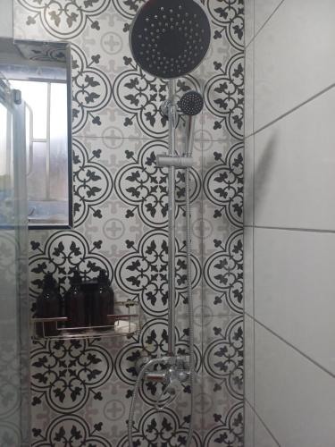 a bathroom with a shower with a mirror at Upendorest in Gaborone