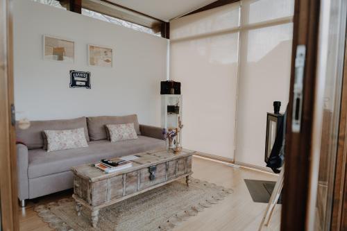 a living room with a couch and a coffee table at Casal Oseira in Ourense
