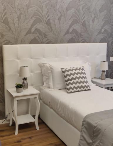 Ένα ή περισσότερα κρεβάτια σε δωμάτιο στο G MARCONI Rooms & Suites