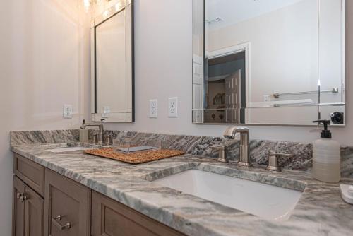 a bathroom counter with a sink and a mirror at Tranquil 2-Bedroom Condo in Hidden Bay Relax & Enjoy Bay Views in Ocean City