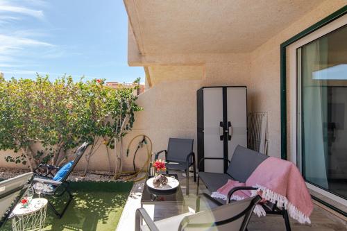 a patio with chairs and a table on a balcony at Refreshing Oasis in El Médano