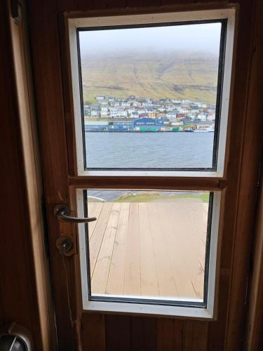 an open door with a view of the water at Sea View Suite in Klaksvík