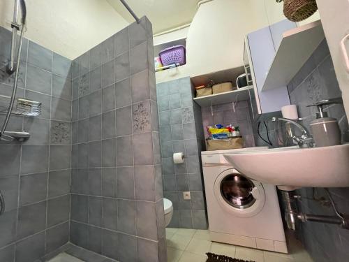 une salle de bain avec une machine à laver et un lavabo dans l'établissement smichel view, à Menton