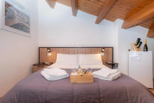 a bedroom with a large bed with shoes on it at Affittacamere - Il Vicoletto in Porto Torres