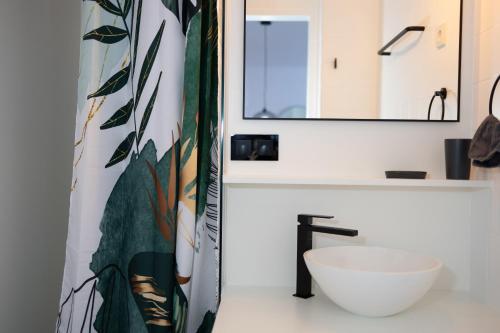 a bathroom with a white sink and a mirror at Das Stadthouse 2 in Gunskirchen