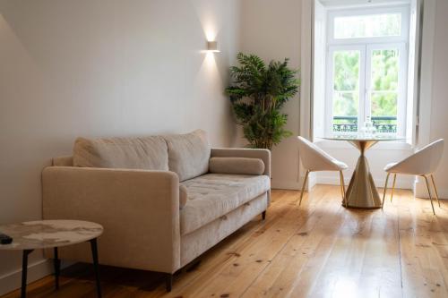 a living room with a couch and a table at Palácio do Visconde - The Coffee Experience in Lisbon