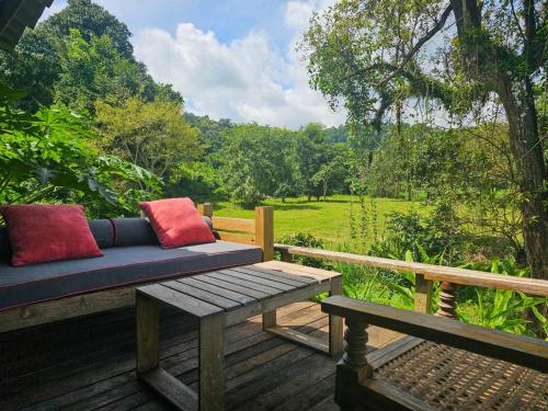 a bench sitting on a deck with a view of a field at NernJamsai in Sop Poeng