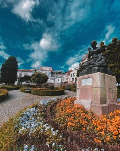 a statue of a little boy sitting on a statute at JM House in Viseu